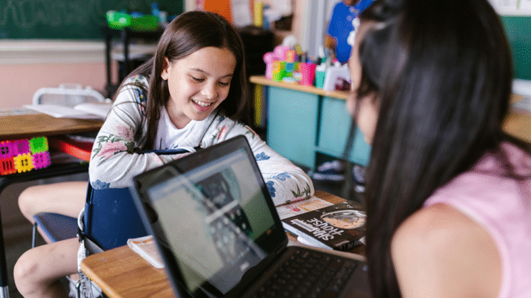 two students in the classroom, learning through laptop, which can say edtech in the