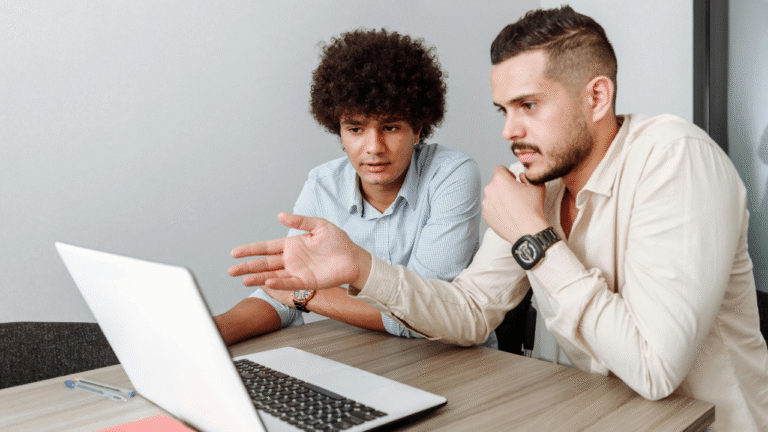 Two men learning through a laptop indicate adaptive learning.