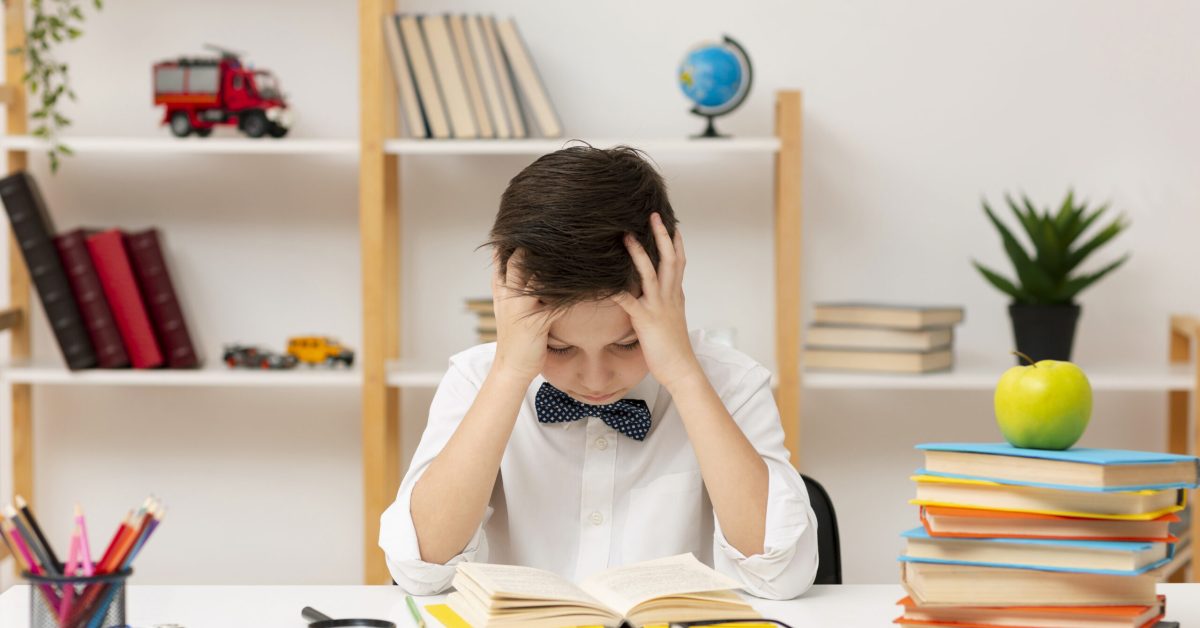 high-angle-boy-concentrated-reading Frustrated student